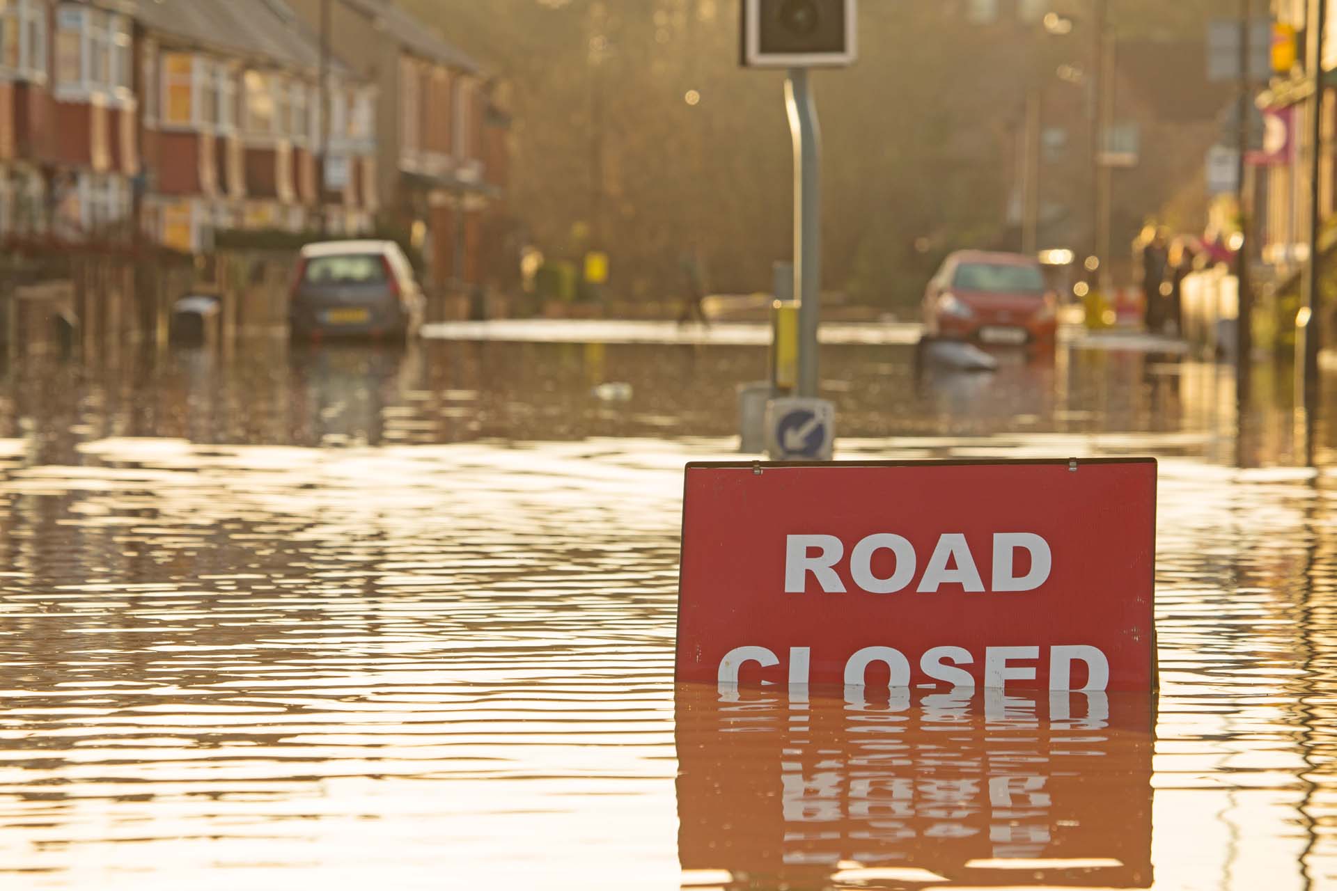 Sign saying Road Closed in front of a flooded road