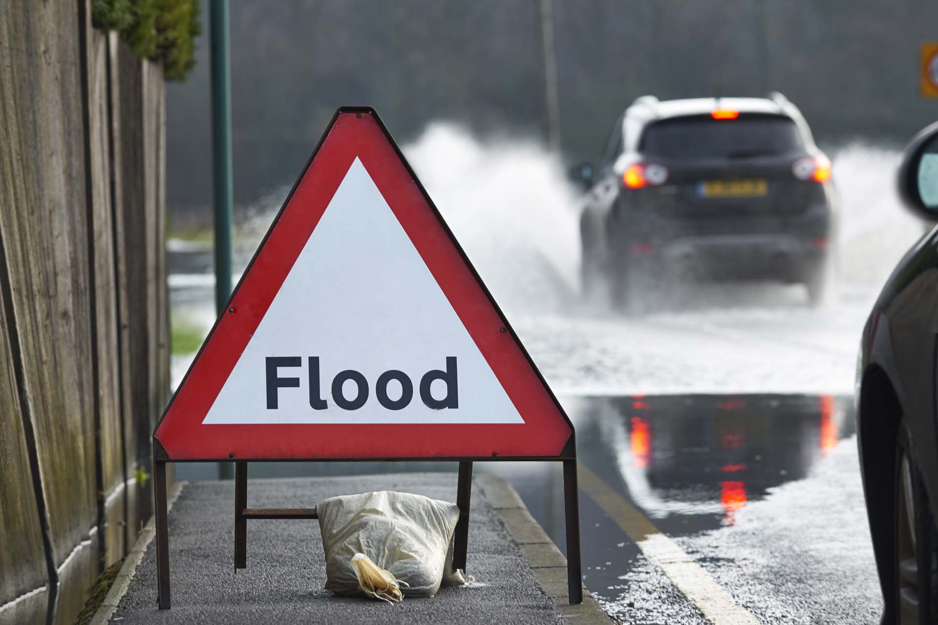 Flood sign in front of a road