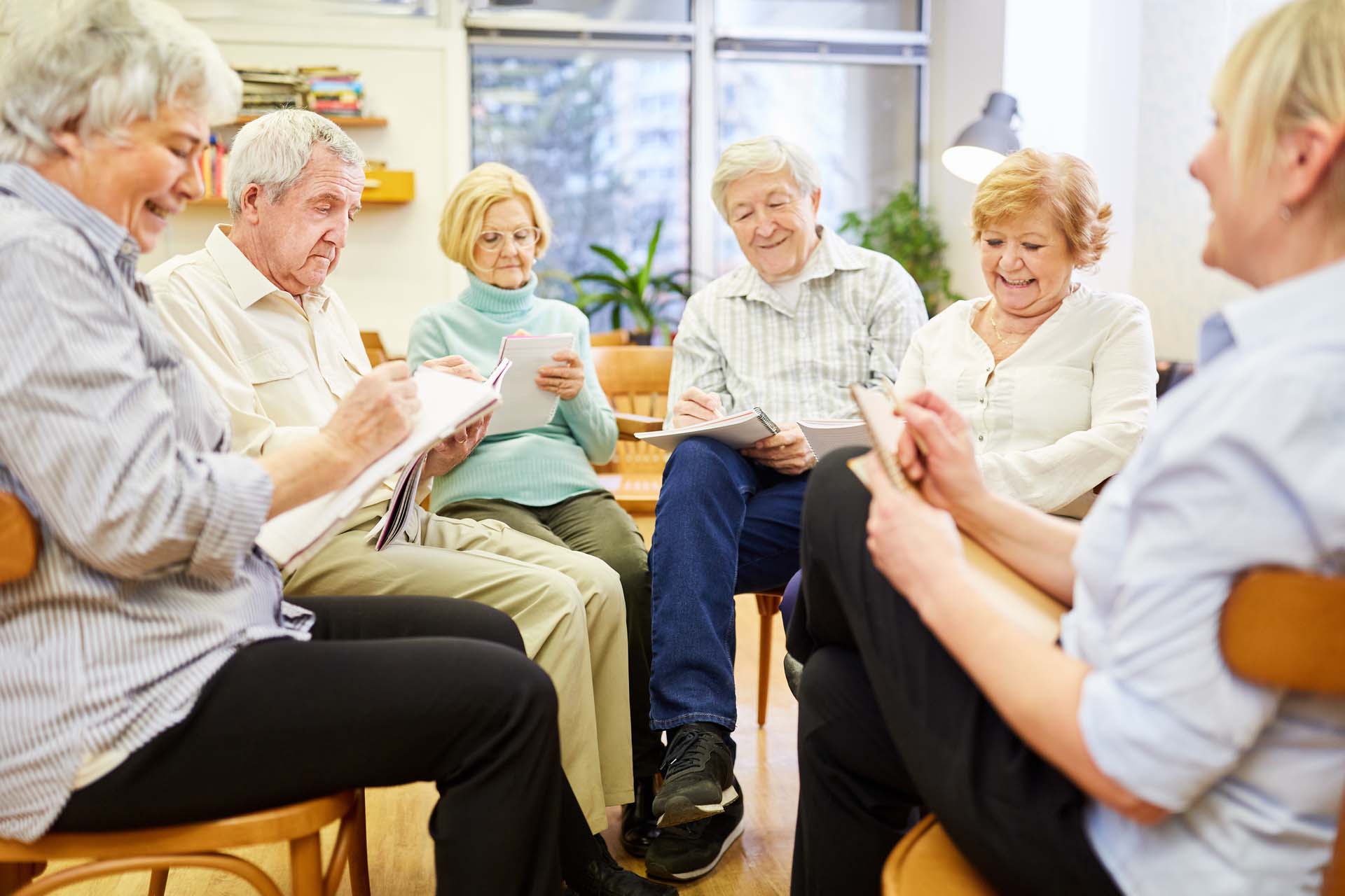 a group of older men and women in a circle at a social meet up