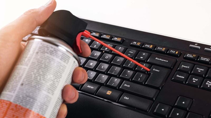 cleaning a keyboard with some air