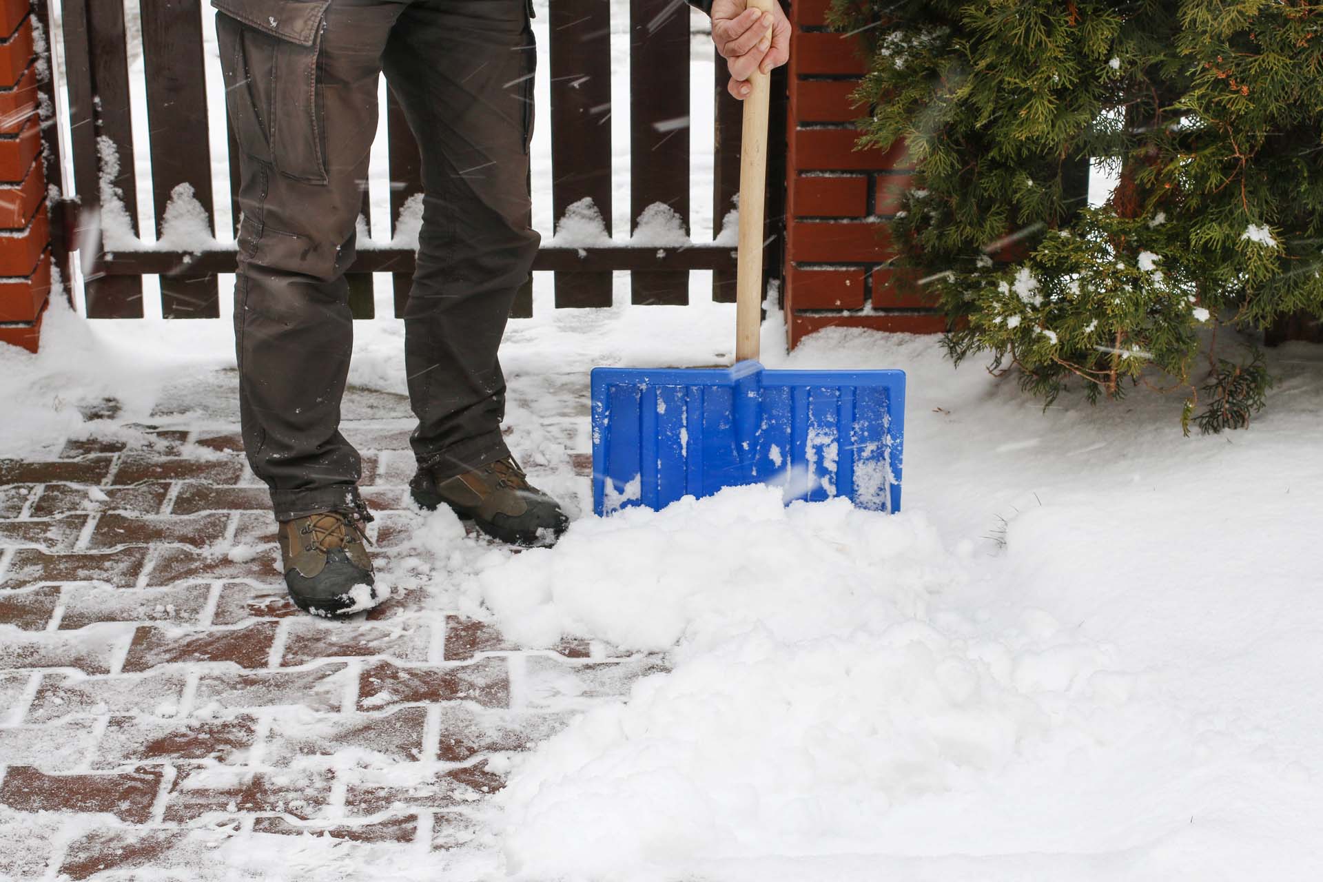 Person shoveling snow from their driveway 