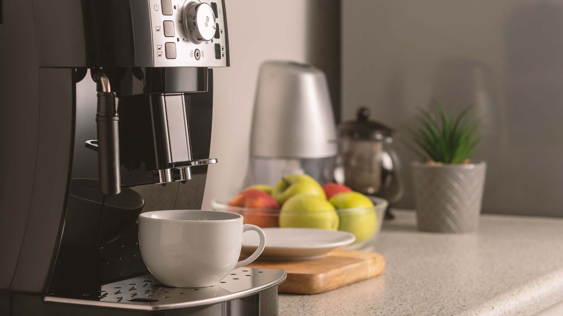 coffee machine on the side with a bowl of fruit