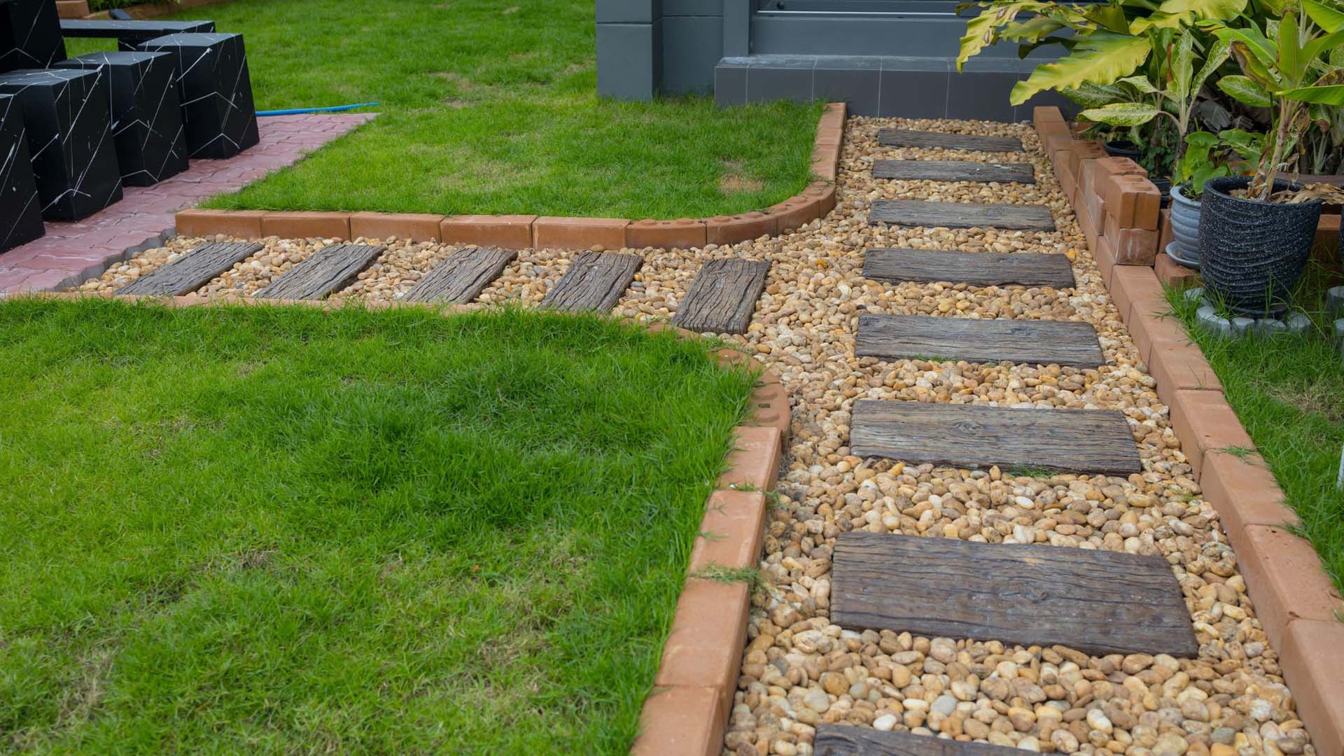 A lawn bordering a path edged with bricks