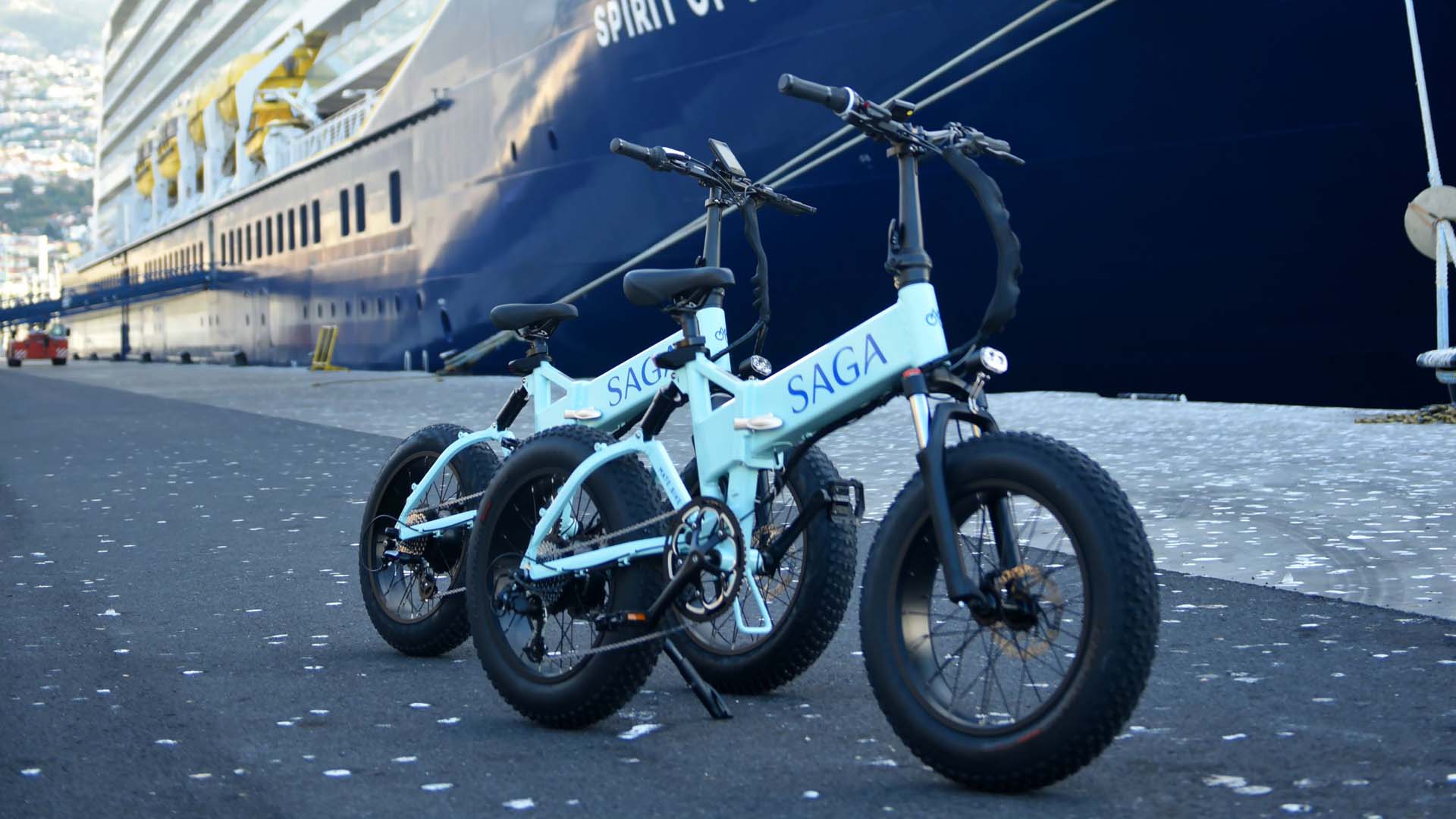 Two Saga Cruise ebikes parked next to the ship