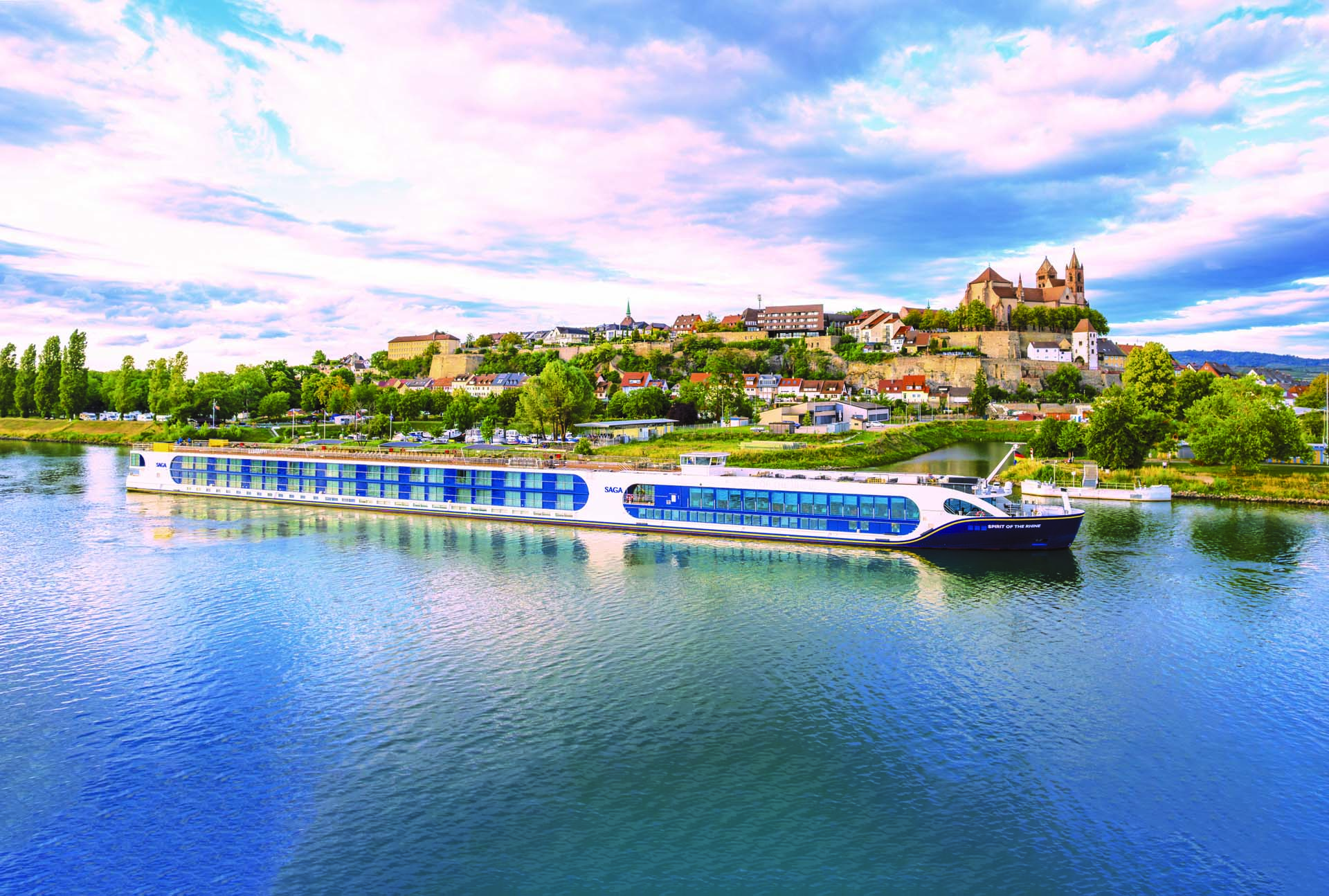 A long river cruise boat moored in front of an old German village on the River Rhine