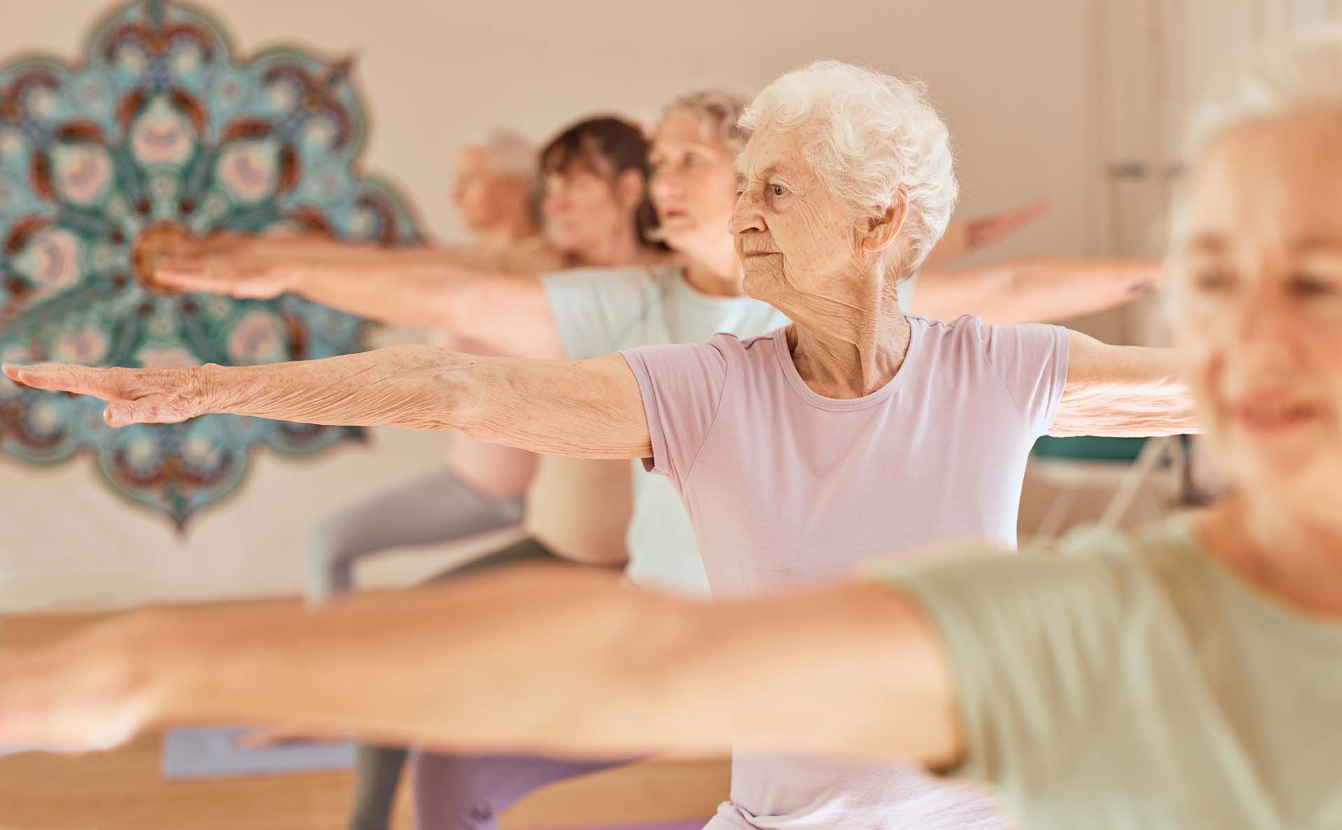 A group of elderly women doing yoga together