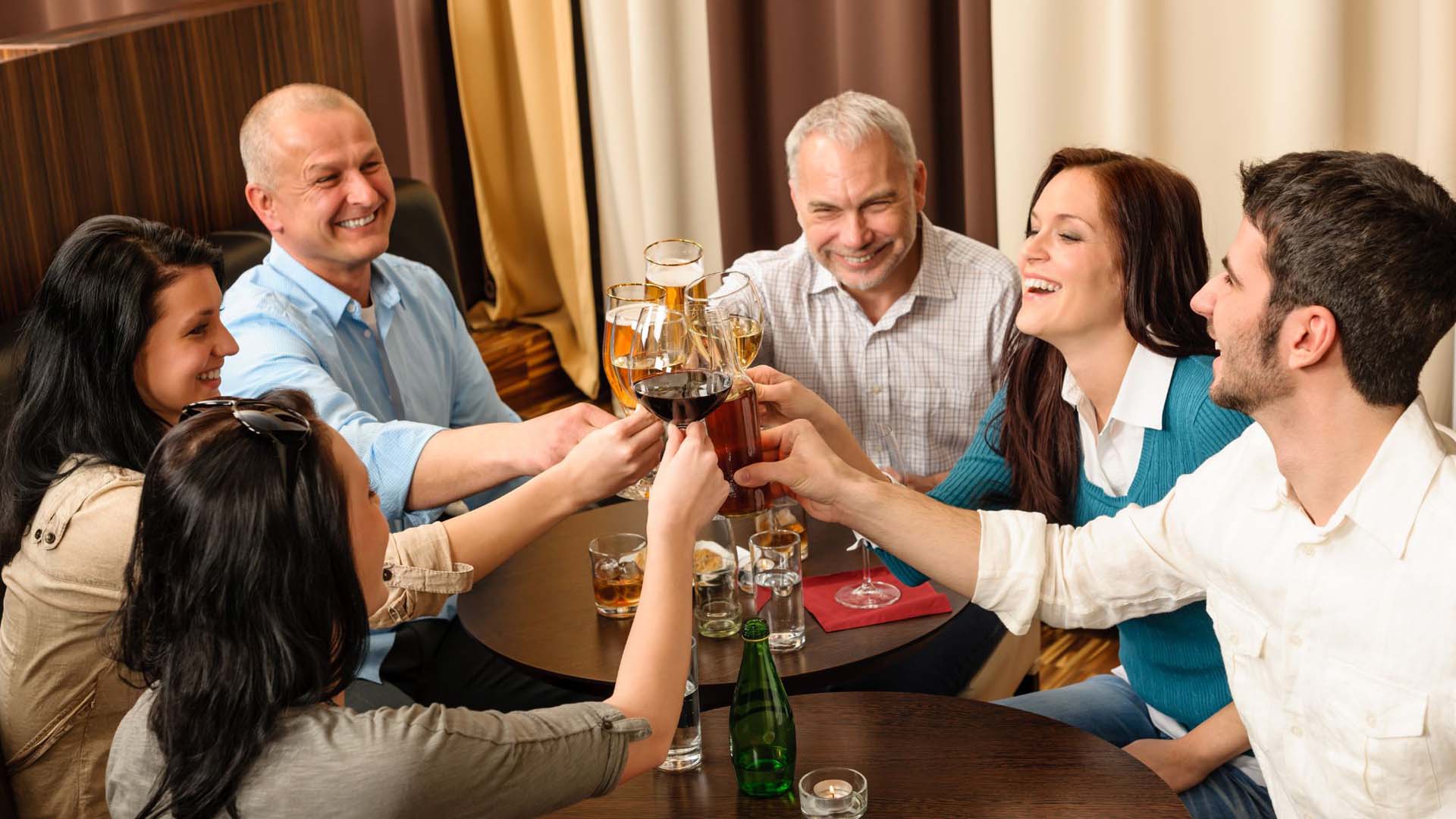A group of friends raising their glasses in a pub