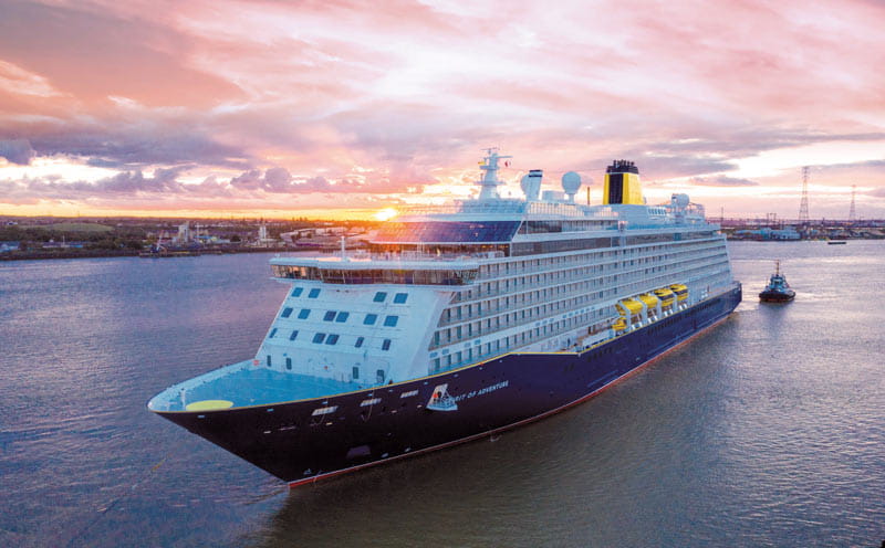 The cruise ship Spirit of Adventure at sea with a tug boat