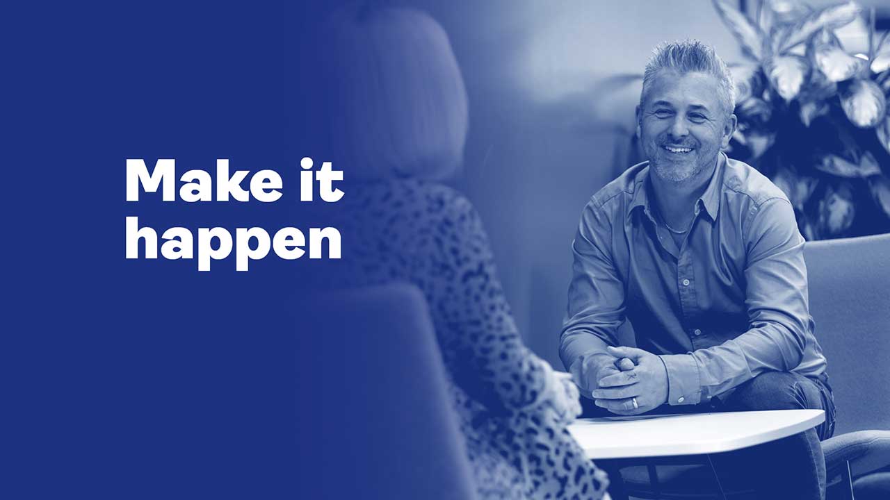 dark blue background with man speaking to woman. Text reads: make it happen