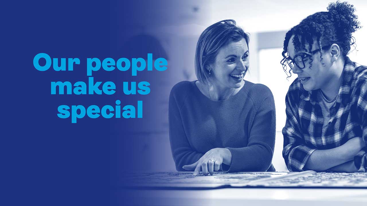 dark blue background with two women talking and completing a jigsaw puzzle. Text reads: our people make us special