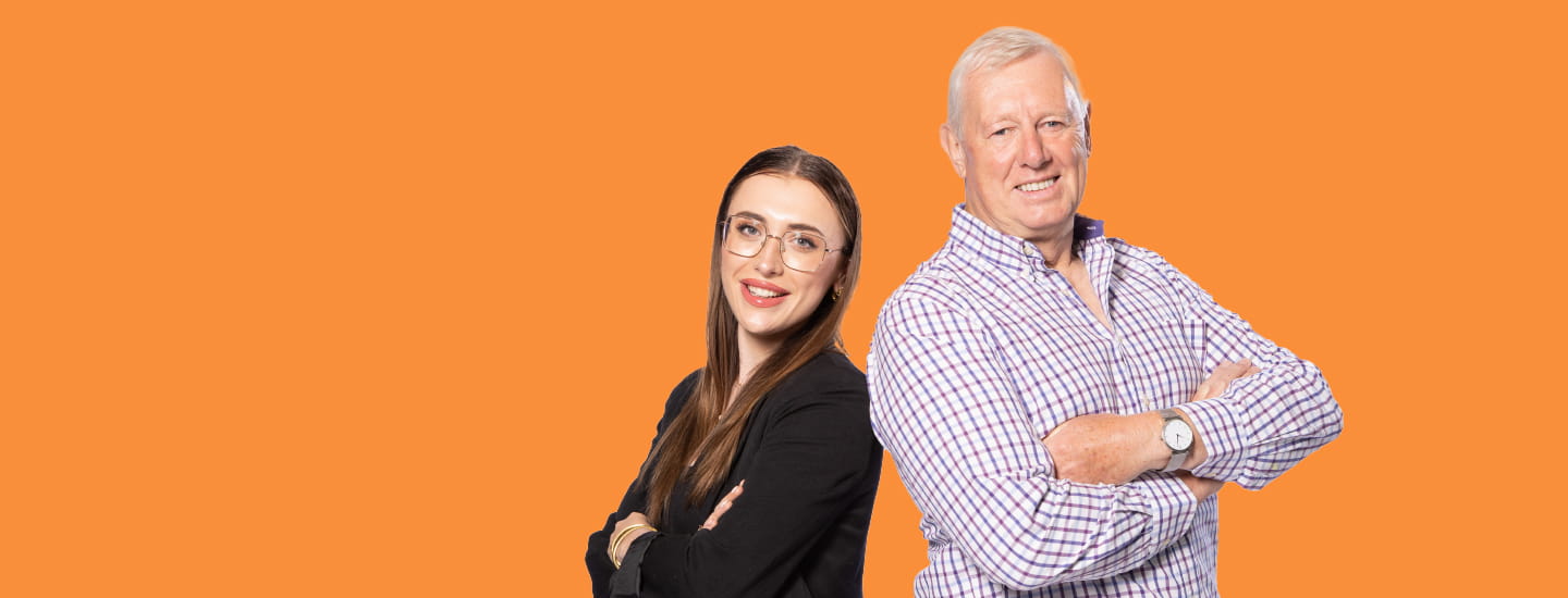 Two people standing back to back on an orange background