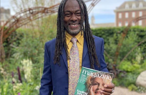 Danny Clarke holding a copy of Saga magazine