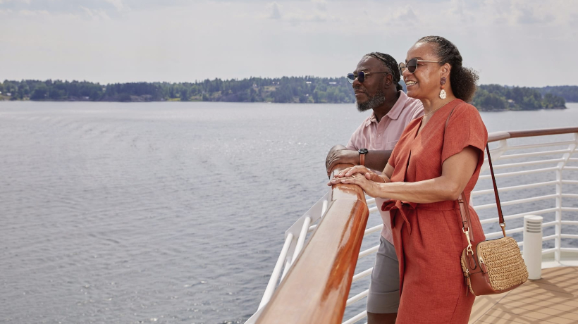 A senior couple on a boat enjoying the view of the ocean