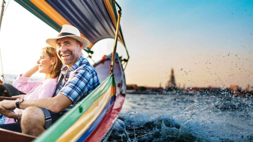 A senior couple enjoy a boat ride on holiday