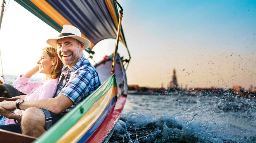 A senior couple enjoy a boat ride on holiday