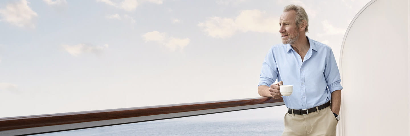 Nicholas Farrell with a cup of tea on the balcony of a cruise ship