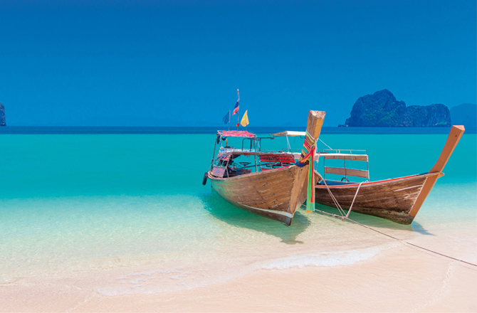 Two small fishing boats with an azure blue sea