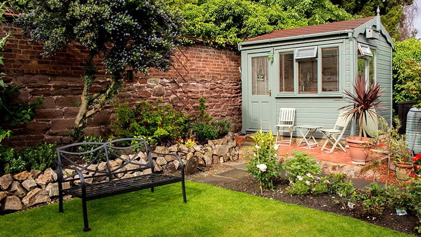 A fancy shed in a pretty residential garden