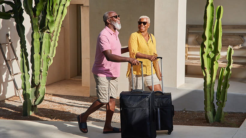 A mature couple arrive at a holiday villa