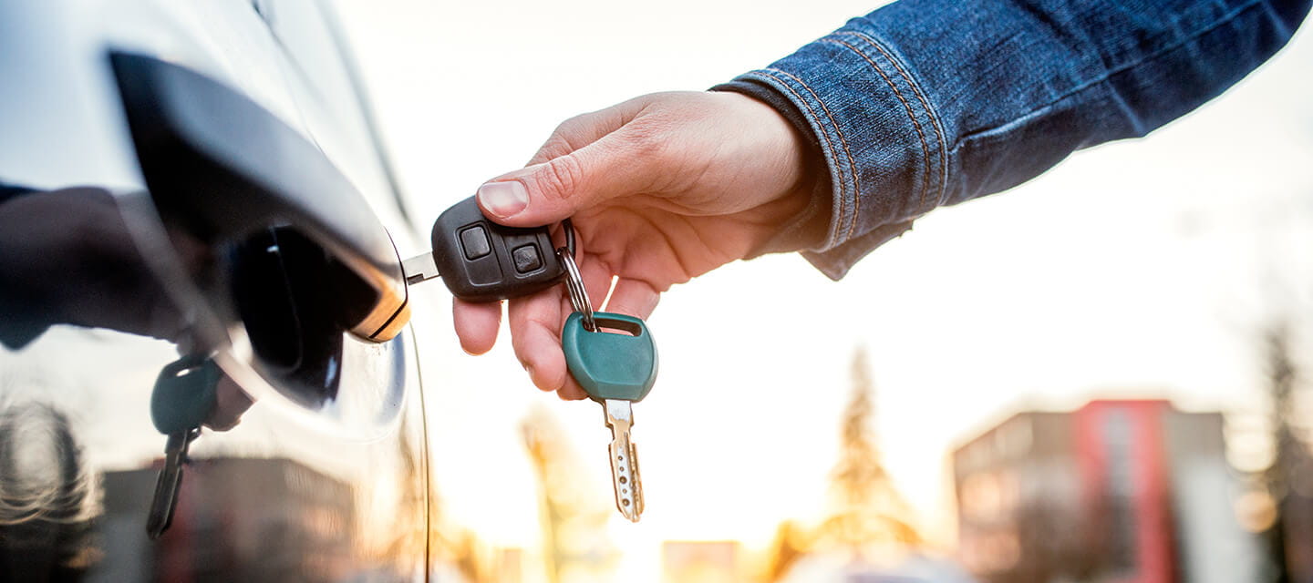 A close up image of a car being unlocked with a key
