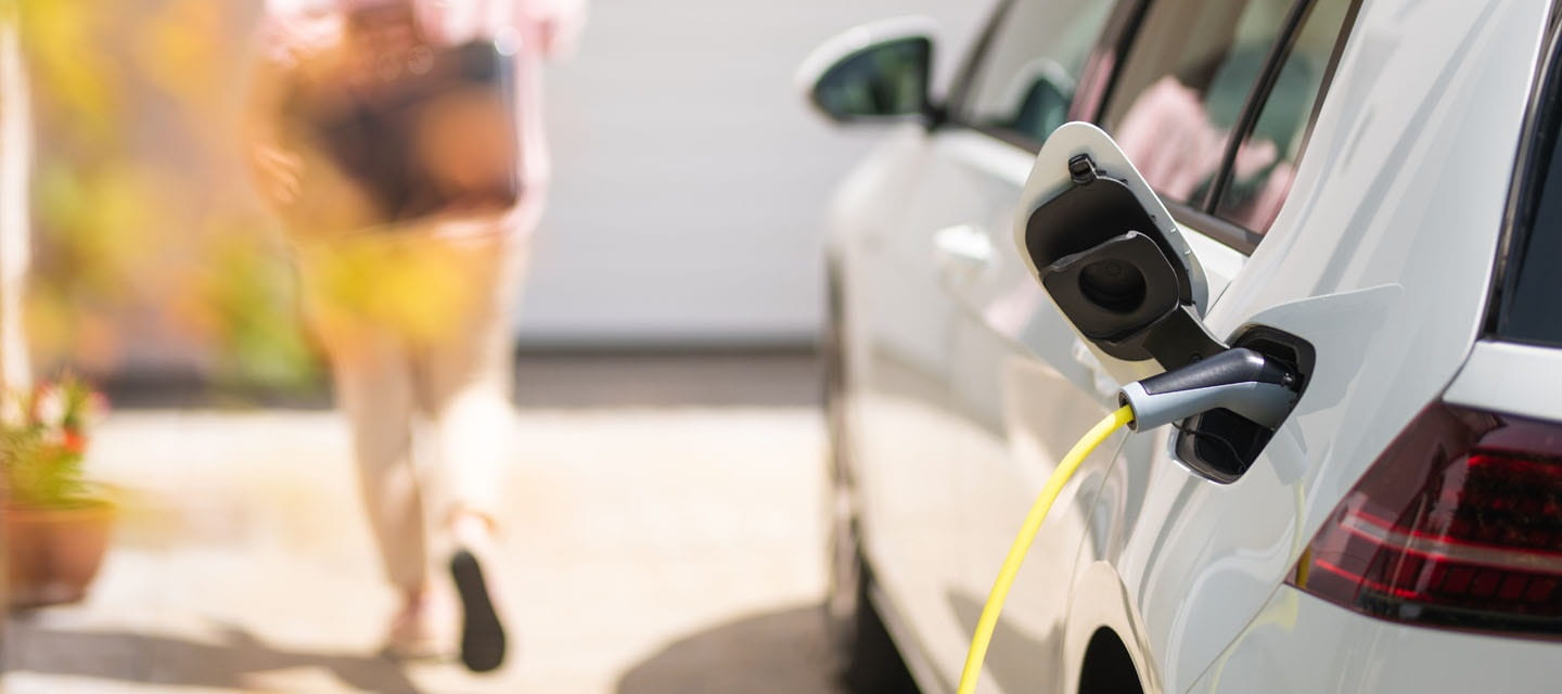 Electric car charging on a driveway at home