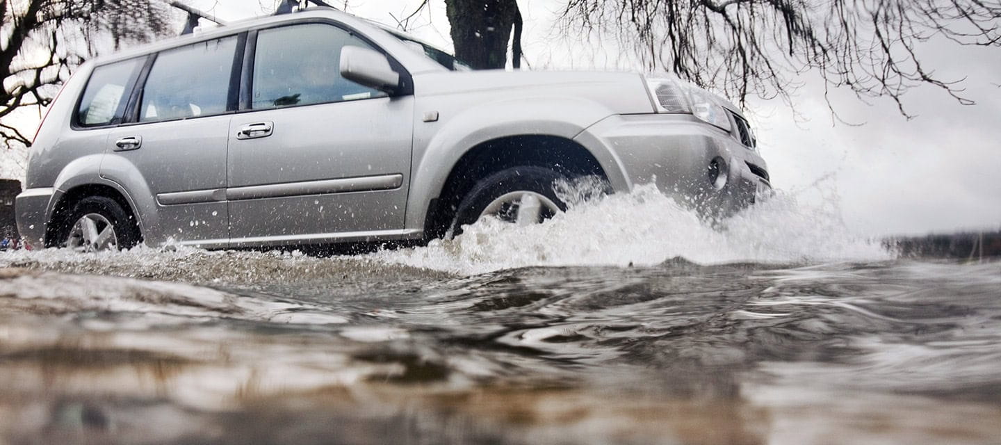 A car driving through floodwater in Ambleside when Lake Windermere broke its banks and spilled over onto the road.
