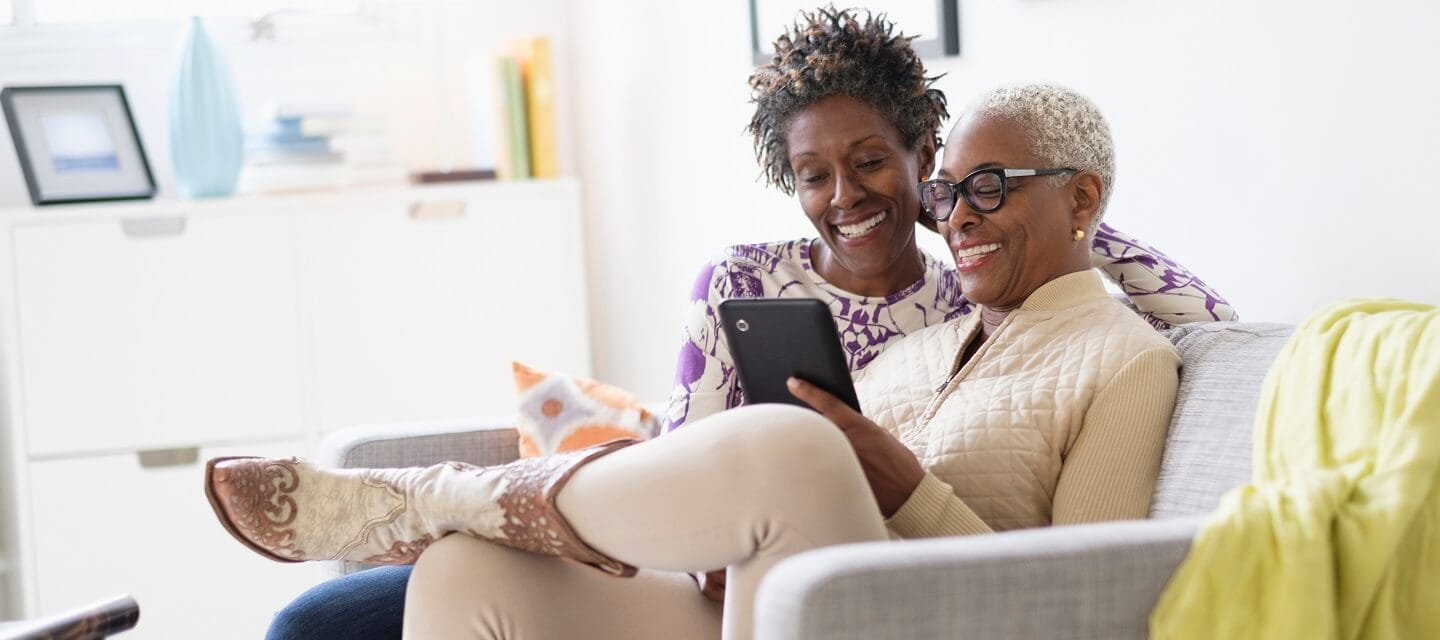 Two women looking at a tablet computer together