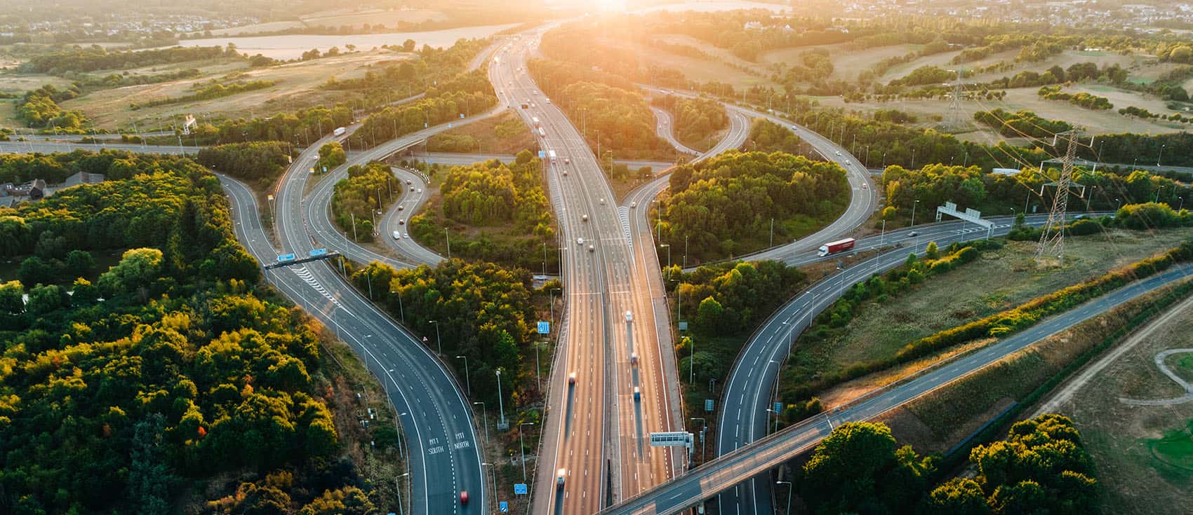 An aerial sunset view of a multi-lane road intersection 