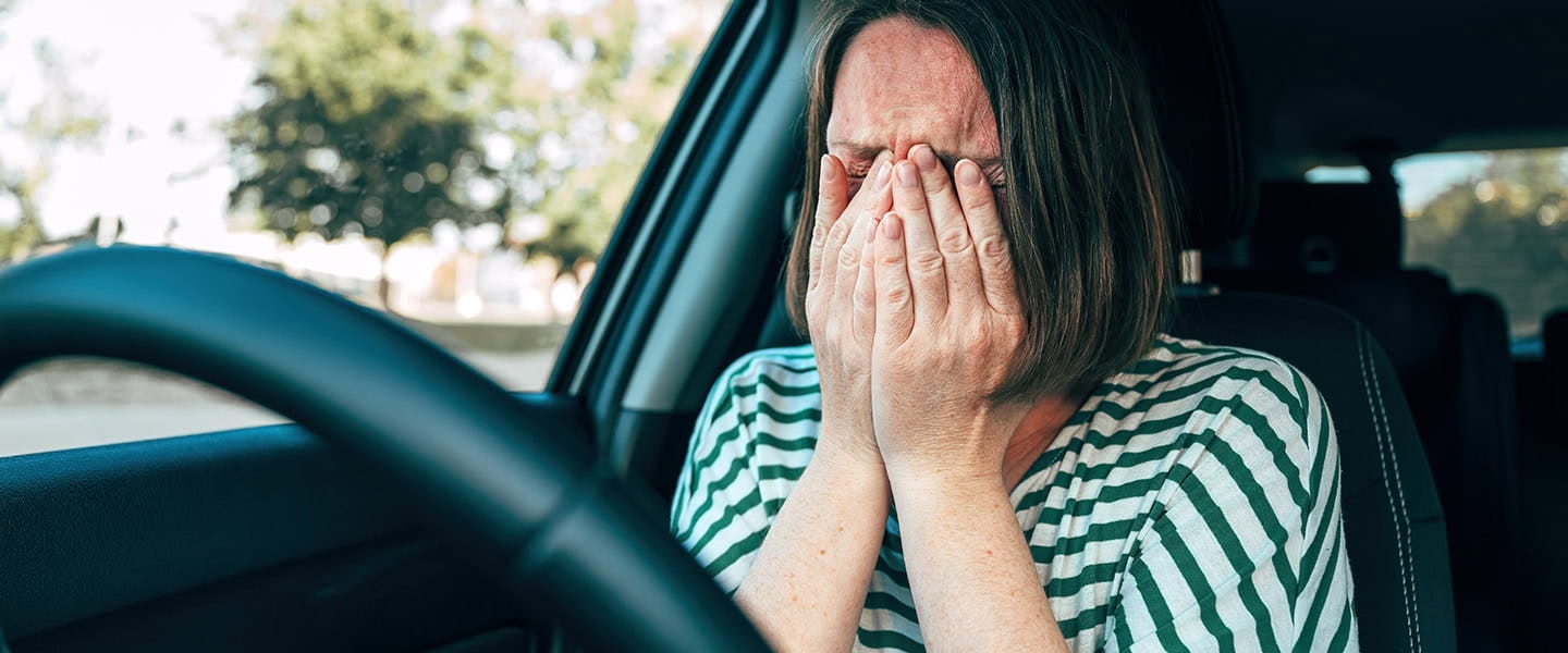Sad driver crying in their car