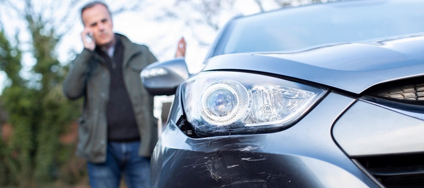 A man on the phone to his car insurance company