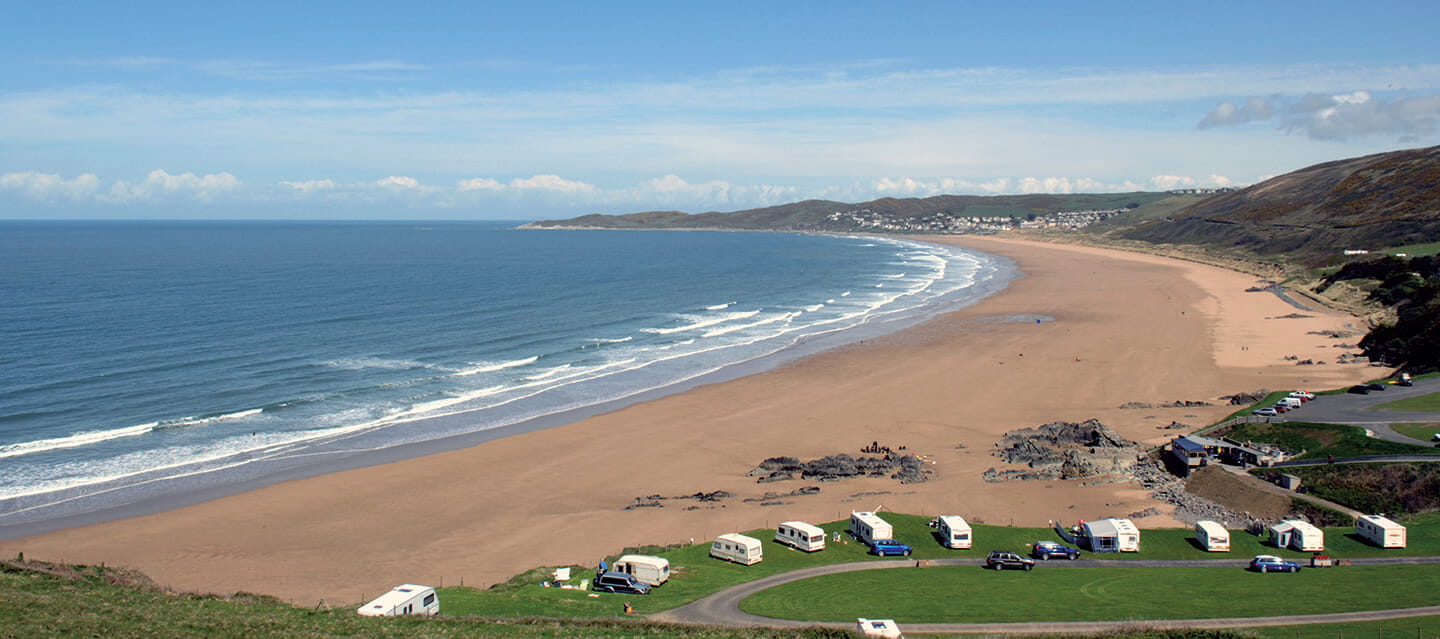 Aerial view of a caravan park next to the beach