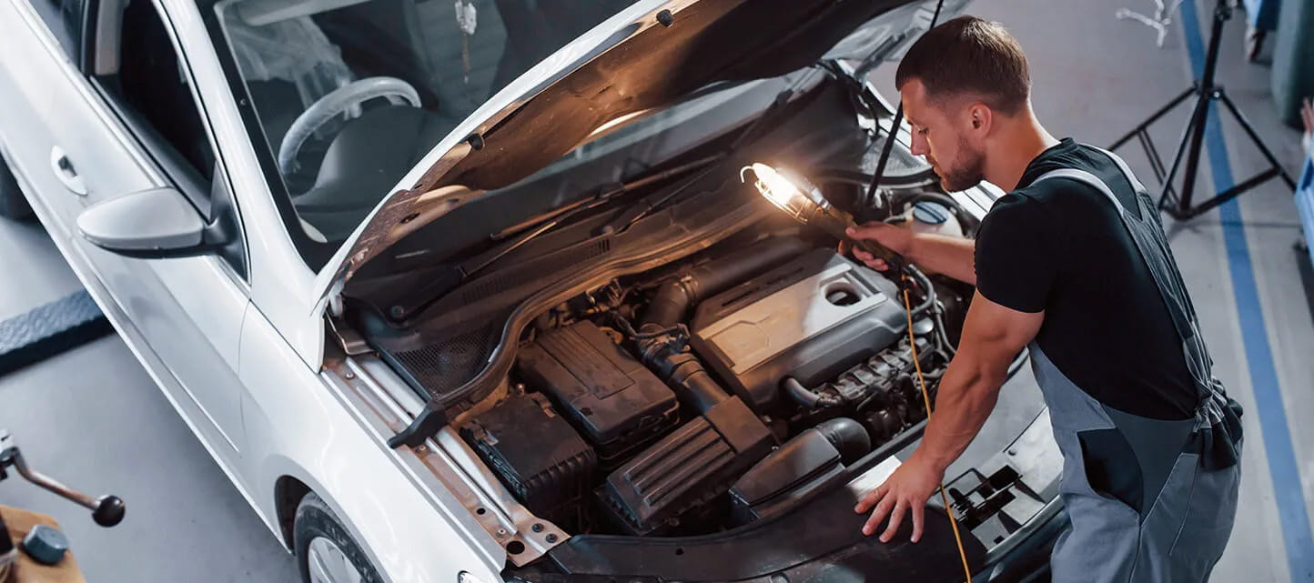 Man looking at car engine