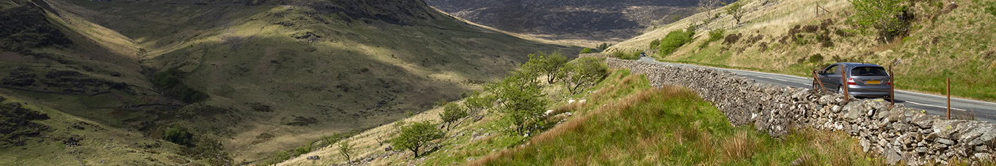 Car on a road in the mountains of Snowdonia national park, North Wales