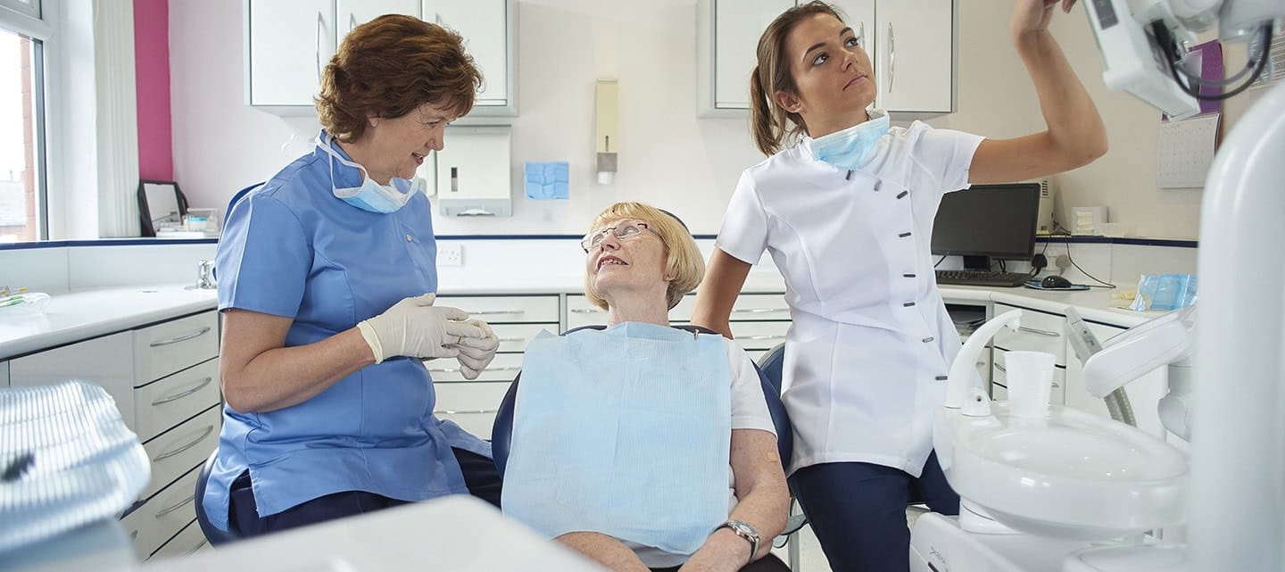 A senior woman having a dentist appointment.