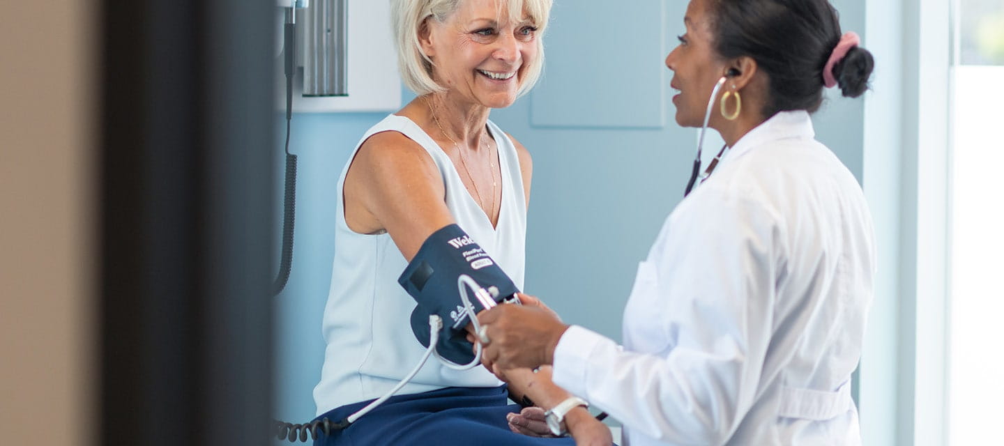 A mature woman having her blood pressure taken