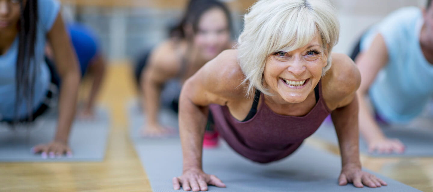 A mature woman enjoying a yoga class