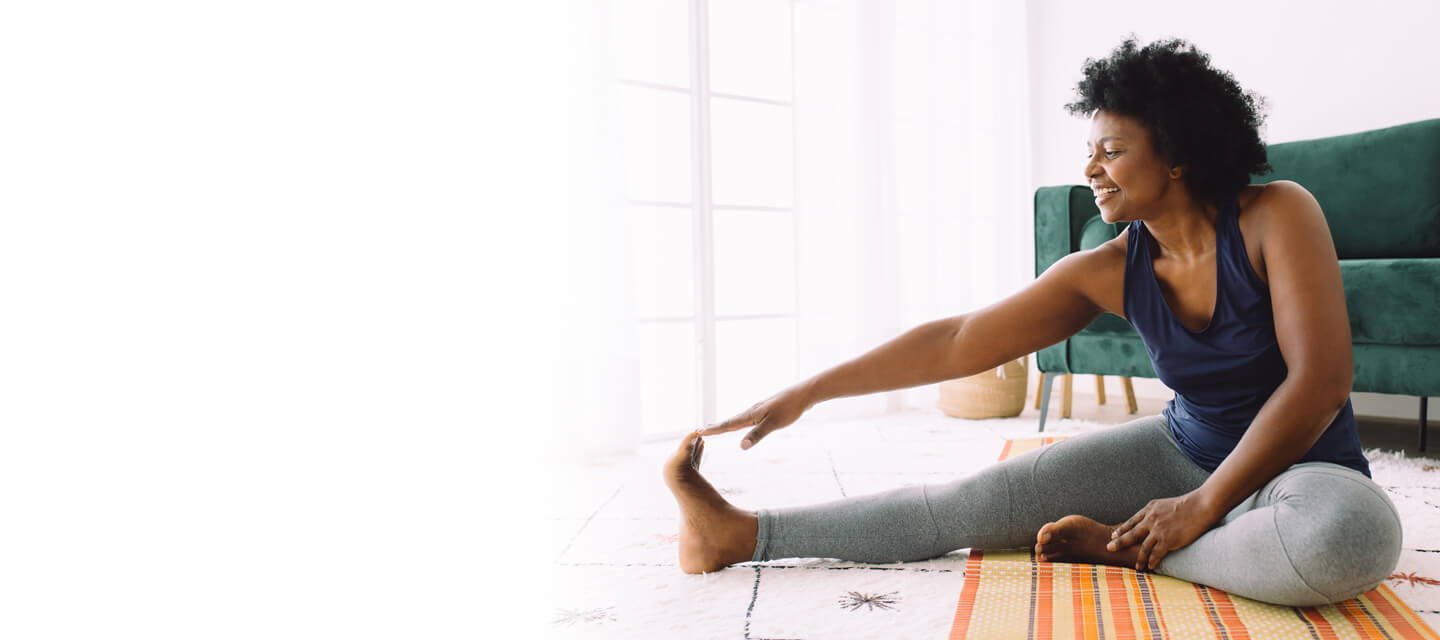 An active woman doing yoga in her front room