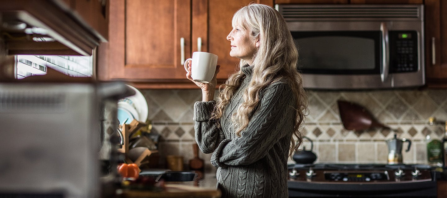 Portrait of a mature woman having coffee in kitchen