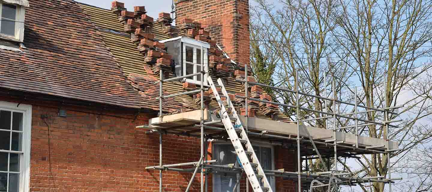 A house with scaffolding being retiled