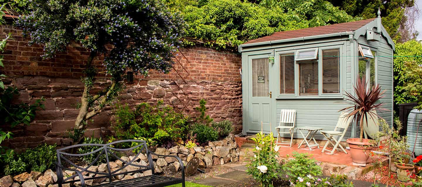 A fancy shed in a pretty residential garden