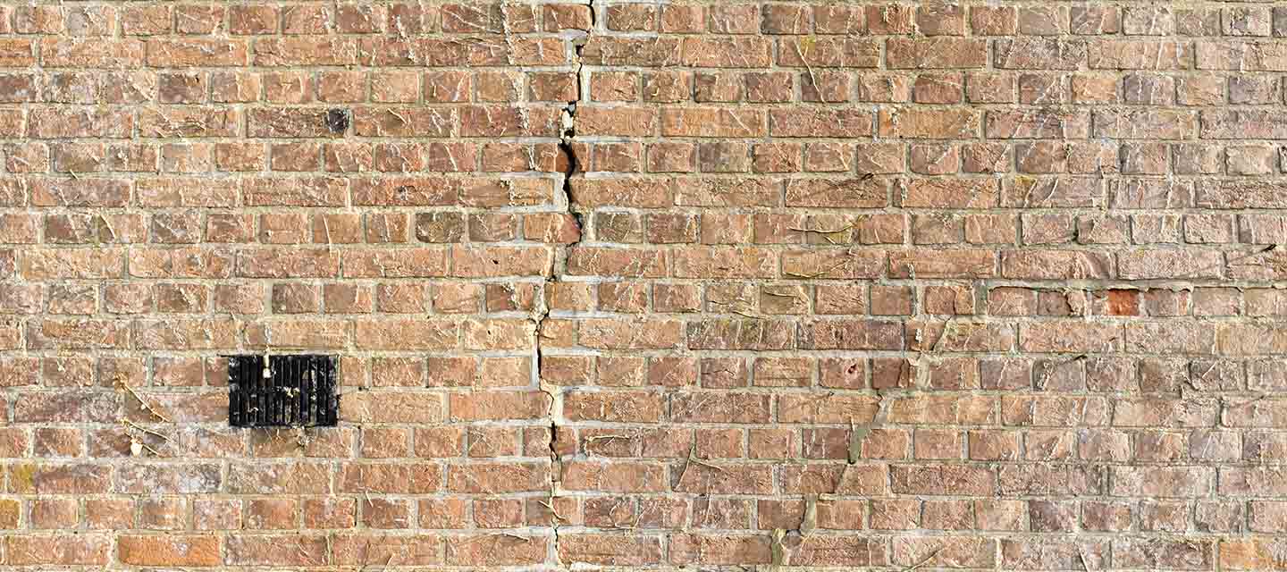 Exposed brickwork with a crack running down the middle