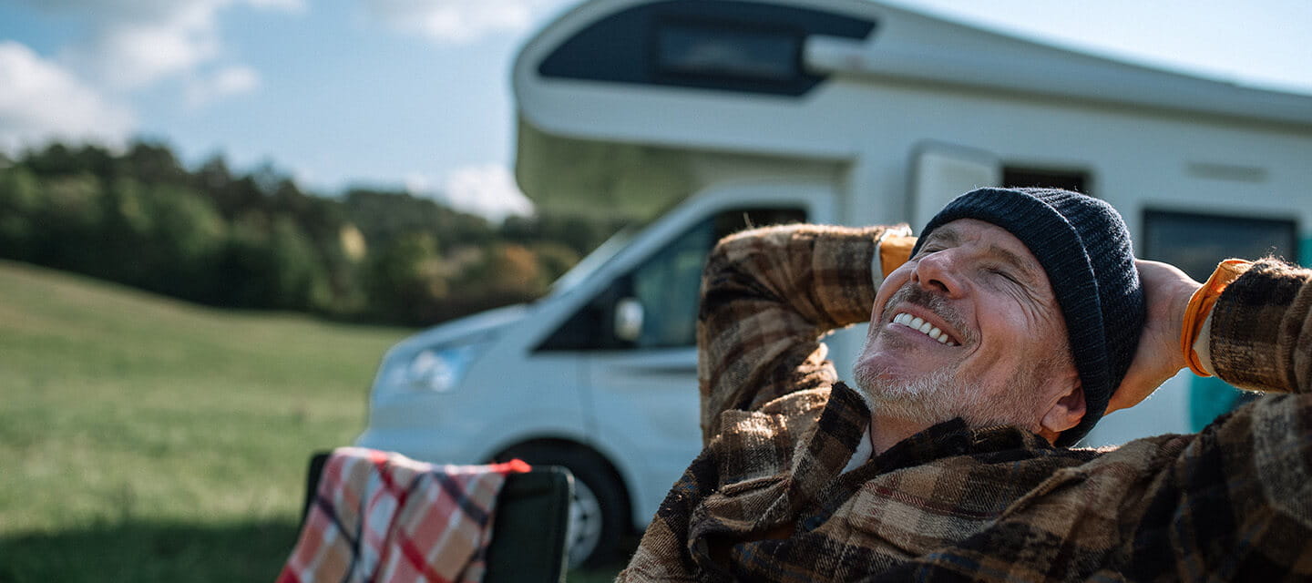 Senior man camping with his motorhome in nature.