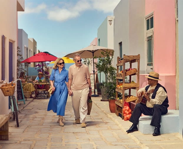 A senior couple walking through a local town on holiday