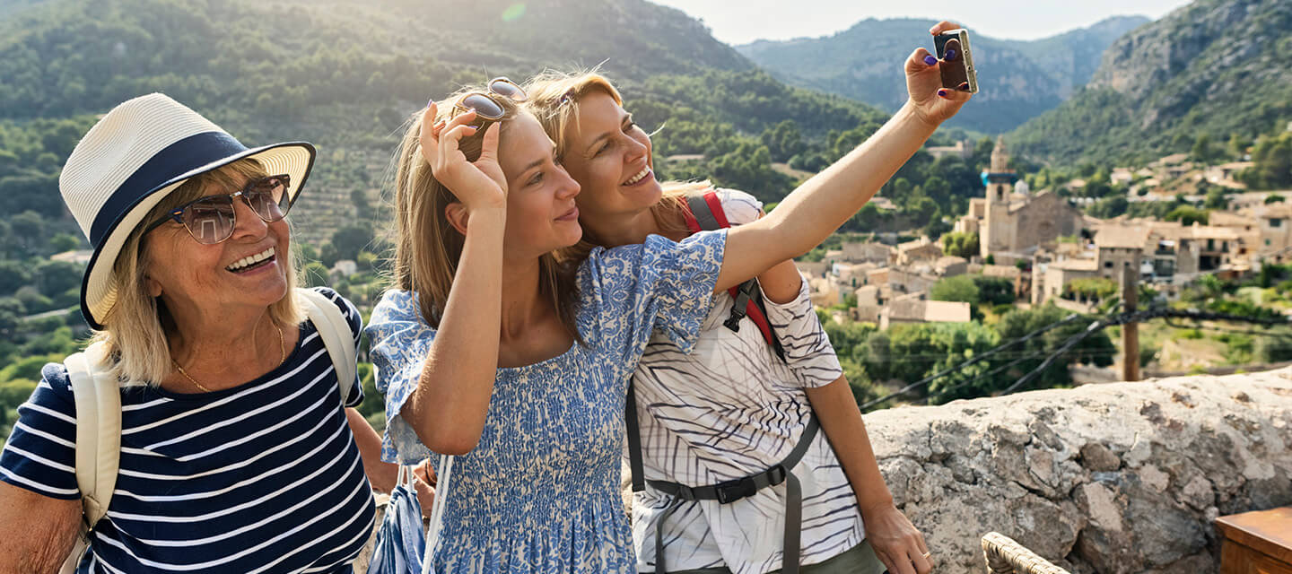 Teen, mother and grandmother are sightseeing in a beautiful Spanish town
