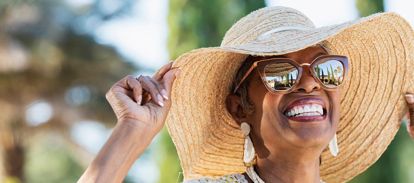Senior woman smiling and wearing sunglasses