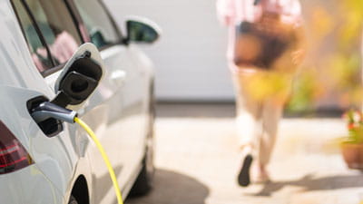 Electric car charging on a driveway at home