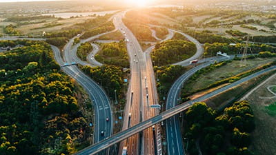 An aerial sunset view of a multi-lane road intersection 