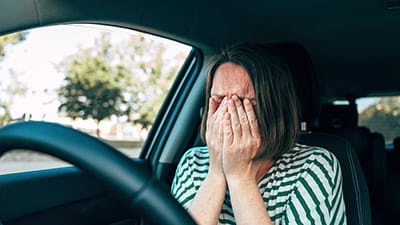 Sad driver crying in their car