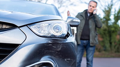 A man on the phone to his car insurance company