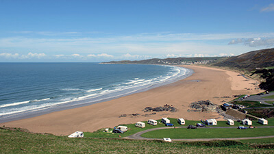 Aerial view of a caravan park next to the beach